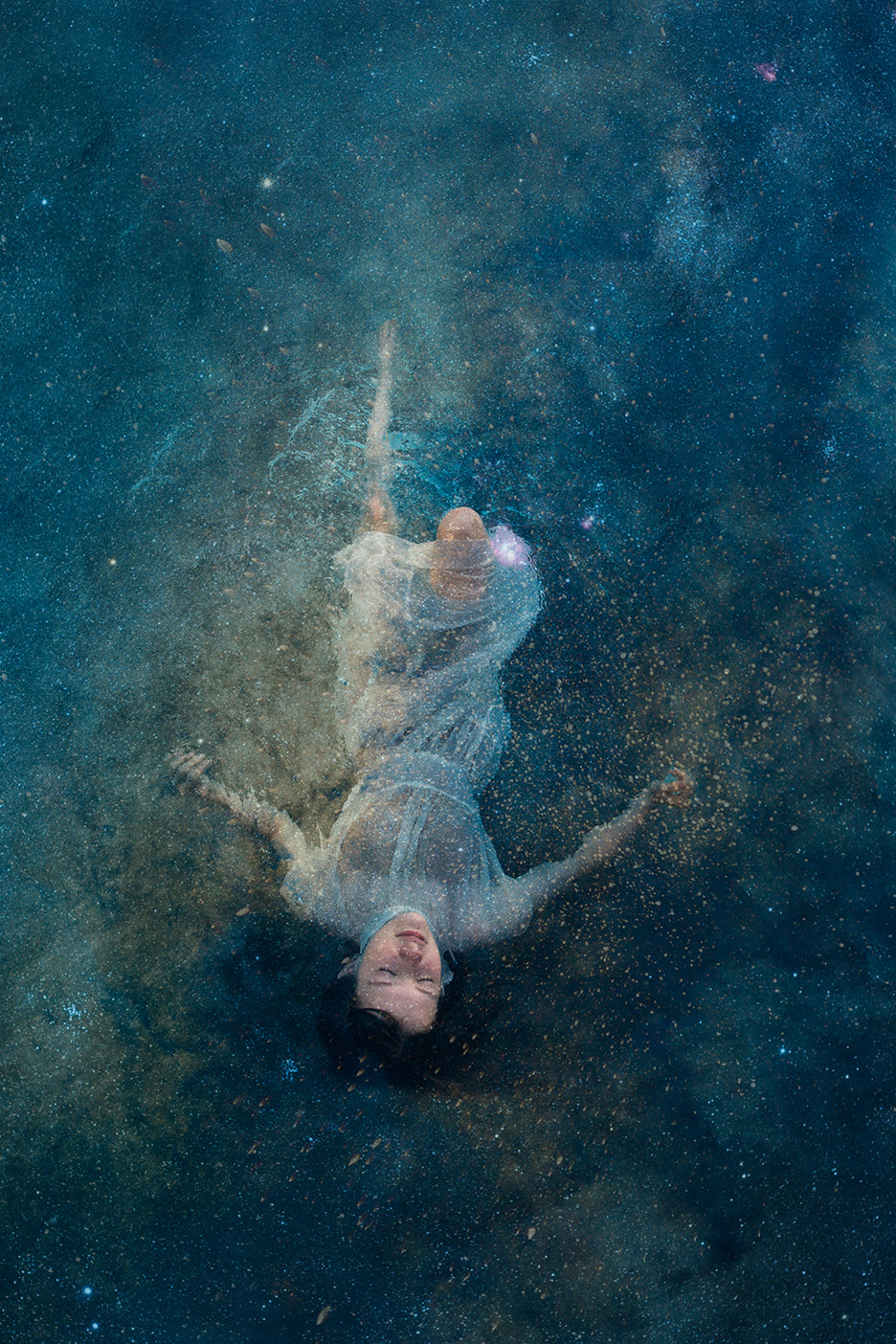A ethereal image of a person appearing to float or be levitated in a starry night sky background, representing a blend of human form with celestial themes.