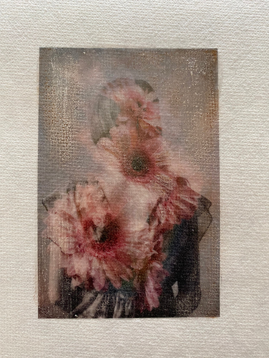 A mini hand-painted artwork featuring a floral design with gold accents, set in an antique gold frame.