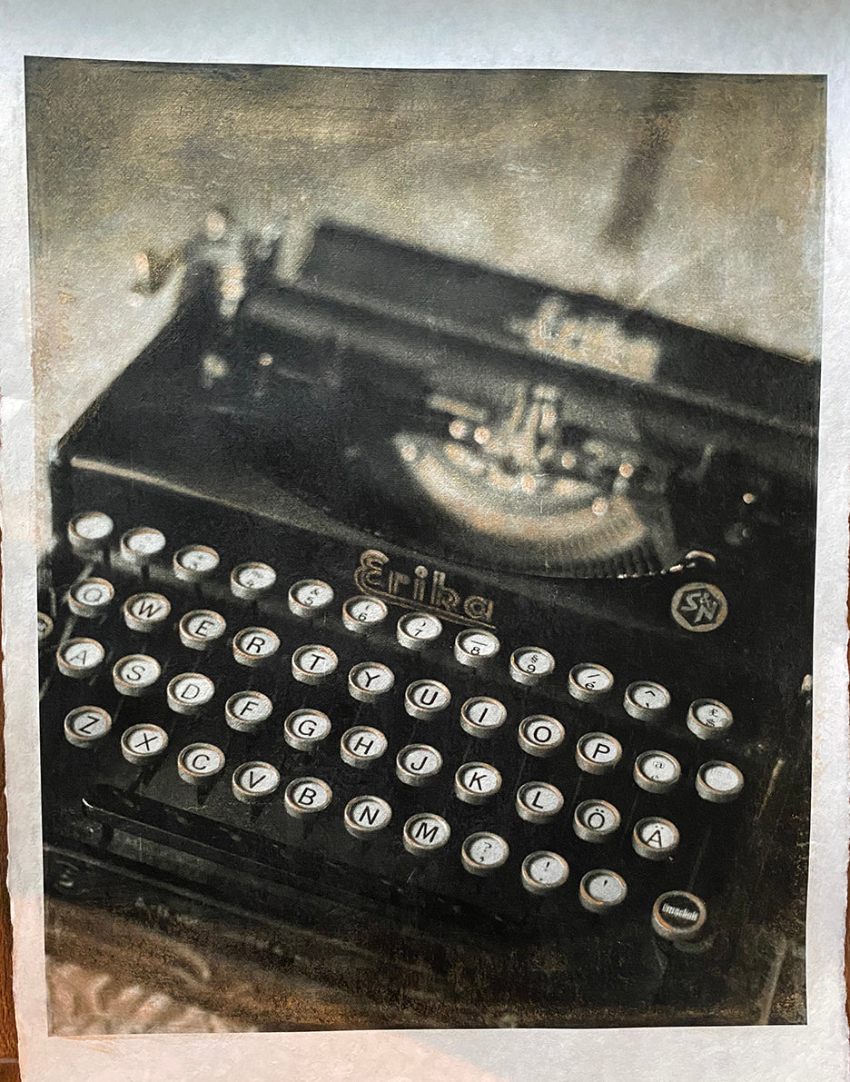 A hand-painted black and white image of a vintage typewriter, with gold accents on the ink keys and paper edges.