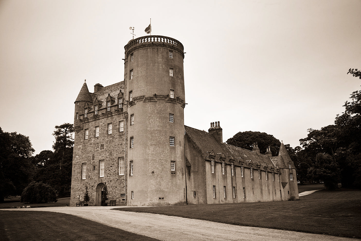 A black and white photograph of Fraser Castle in Scotland with a sepia tone, characteristic of the artwork described.