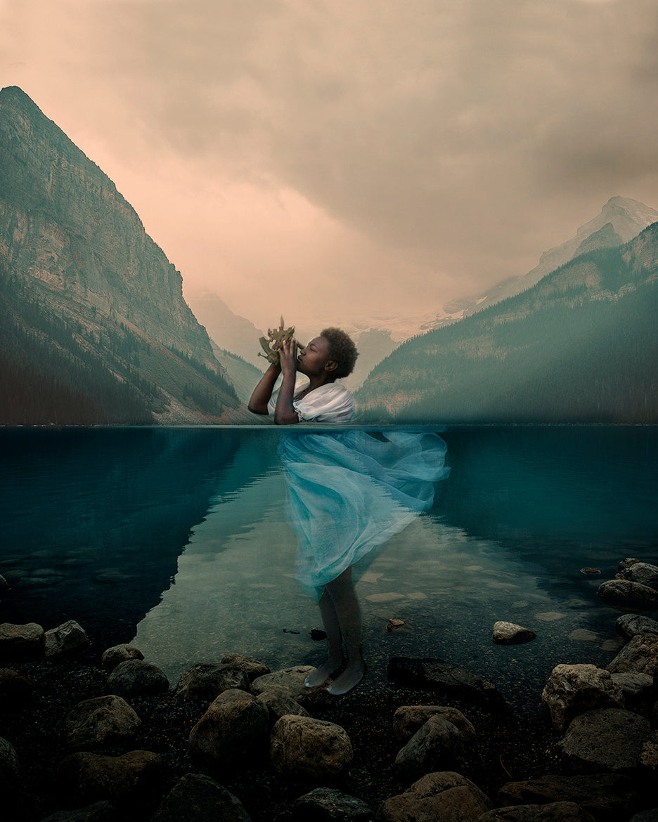 girl with dark skin underwater holding a sextant to navigate life
