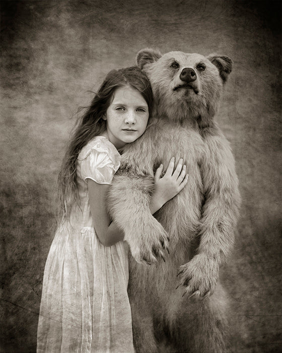 Young girl with light tan bear