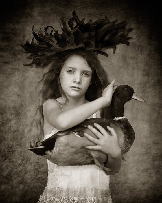 girl holding and petting a wild Mallard duck