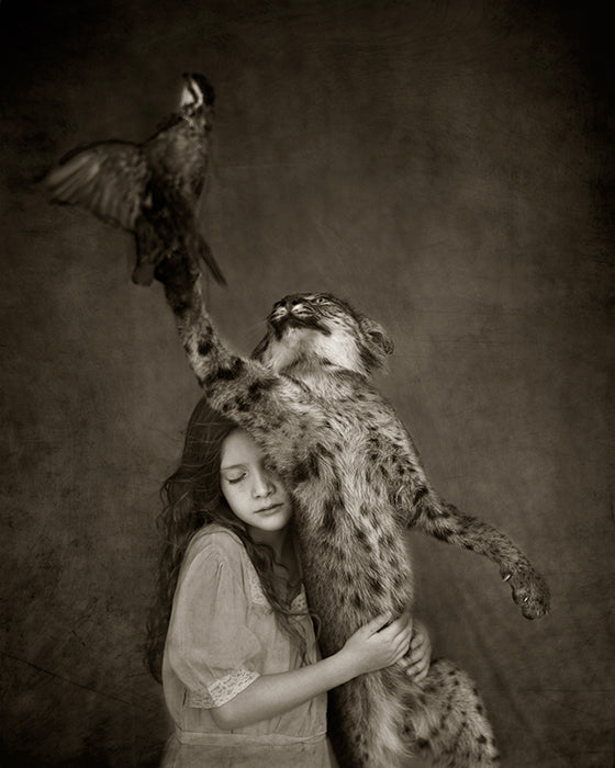 girl holding onto a wild bob cat