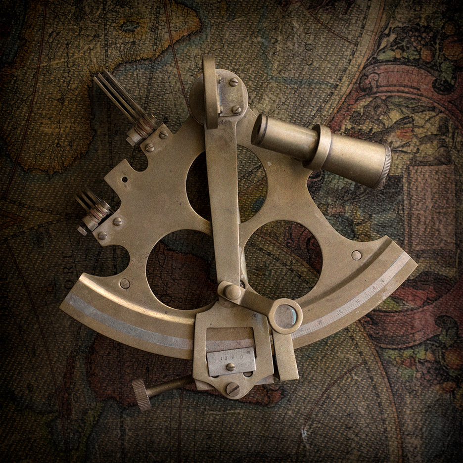 Vintage brass sextant placed on an old map background, suggesting a nautical theme.