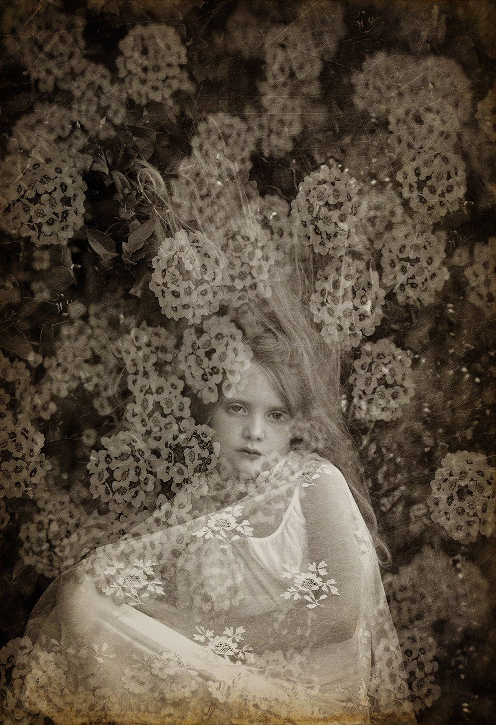 A black and white photograph of a person with floral patterns overlay, depicting a blend of human and floral elements, suggestive of the 'Bella Flora' theme.