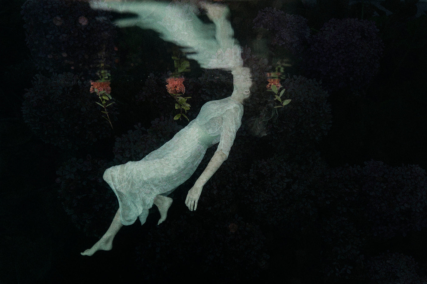 An ethereal image of a figure floating in water, with a blurred background, capturing a whimsical and mystical atmosphere.
