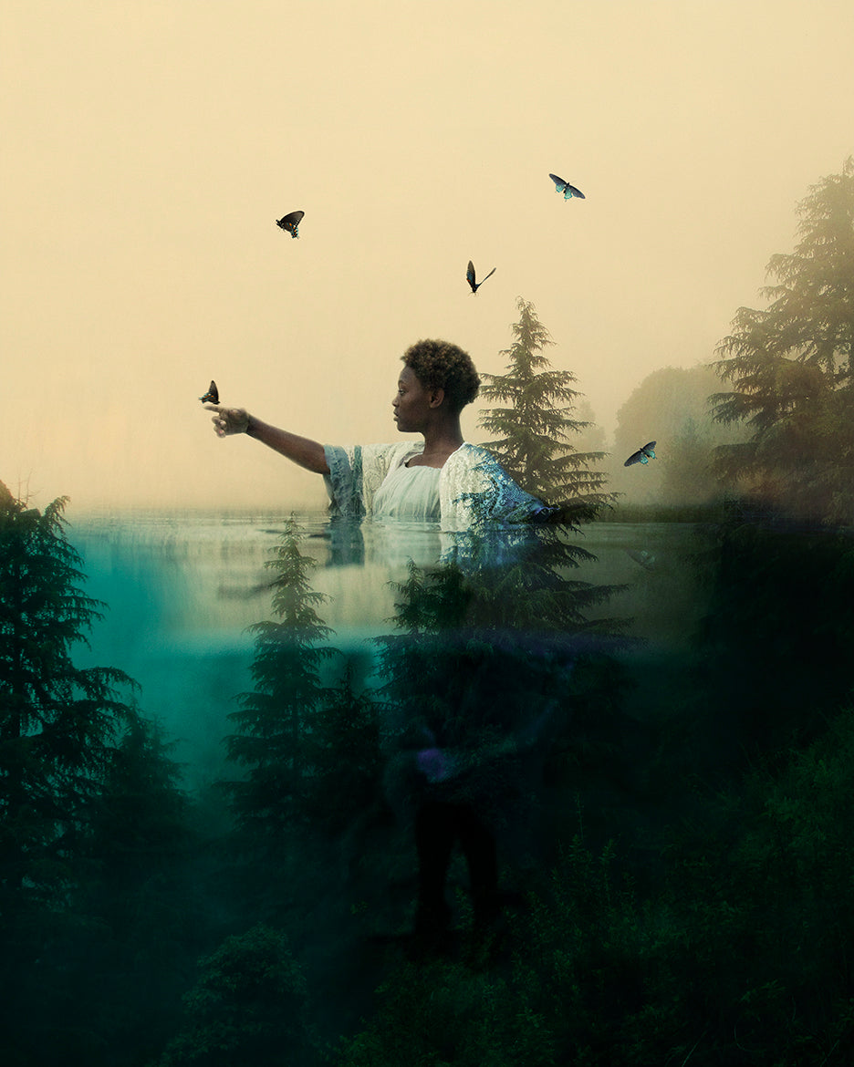 A girl reaching out towards butterflies in flight, with a double exposure effect incorporating elements of nature such as trees and water.