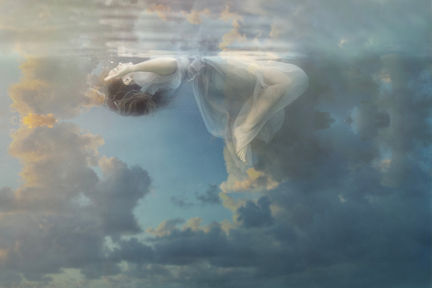 A digital artwork depicting a figure with angel wings floating above a serene underwater scene with a cloudy sky in the background, representing a mystical and spiritual theme.